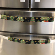 Stainless steel refrigerator with decorative Christmas tree handle covers.
