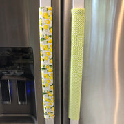 Stainless steel appliance with mint green textured handle cover and lemon-patterned handle cover.