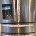Handmade rose pink snowflake covers on refrigerator handles, adding a festive touch to kitchen decor for the holidays.