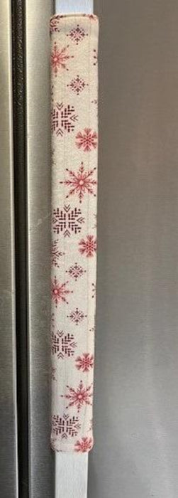 Handmade rose pink snowflake appliance handle cover adding festive decor to kitchen appliances.