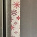 Handmade rose pink snowflake appliance handle cover adding festive decor to kitchen appliances.