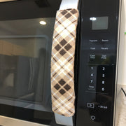 Plaid-patterned handle covers on a microwave