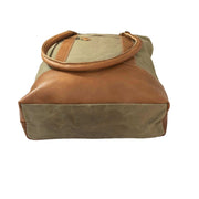 Canvas tote bag with leather trim showcasing spacious design and sturdy materials.