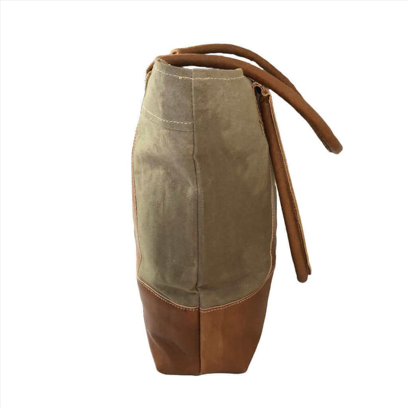 Canvas tote bag with leather trim side view, showcasing sturdy canvas and genuine leather details.