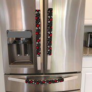 Red and white hearts on black Valentine-themed appliance handle covers.