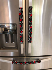 Red and white hearts on black Valentine-themed appliance handle covers.