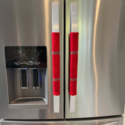 Red cotton flannel handle covers with poinsettia ribbon trim on a stainless steel appliance.