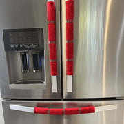 Stainless steel refrigerator with red handle covers featuring poinsettia ribbon decorative elements.