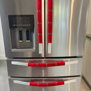 Stainless steel appliance with red handle covers.