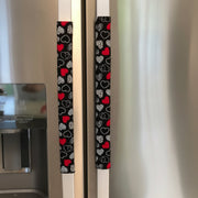 Fridge handles with heart patterned covers on a refrigerator.