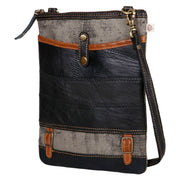 Repurposed canvas crossbody bag made from upcycled materials, featuring zipper top and leather accents for style and durability.
