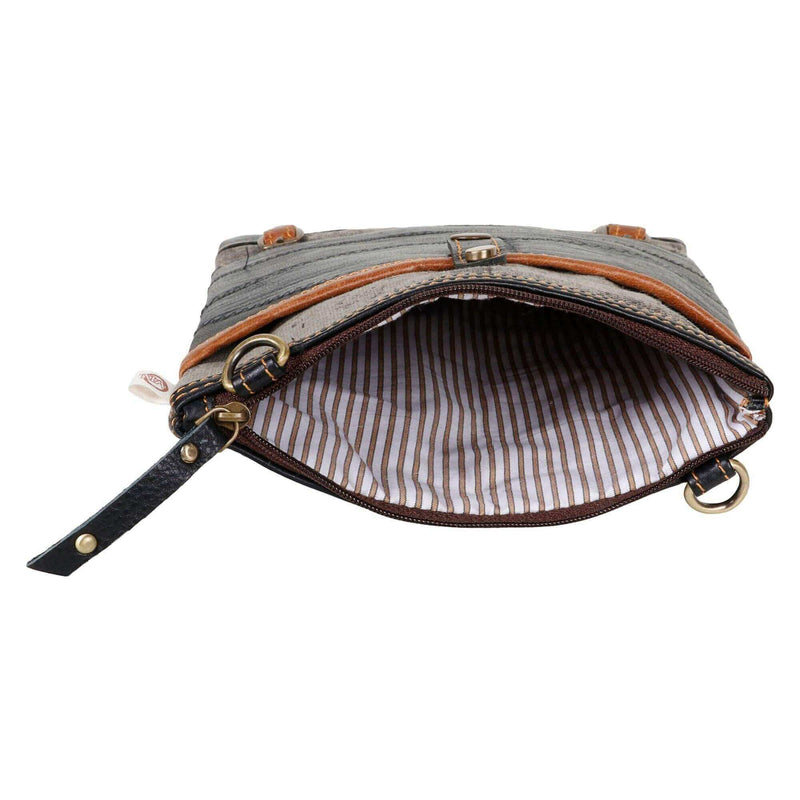 Interior view of a repurposed canvas crossbody bag showing fabric-lined zipper and striped pattern.