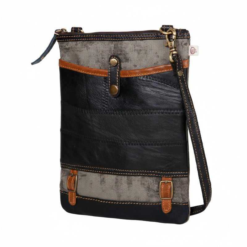 Repurposed canvas and Leathercrossbody bag made from upcycled materials, featuring a zipper top and leather accents for style and durability.