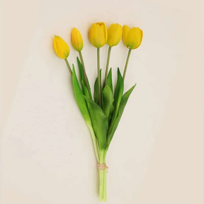 Soft silicone artificial tulip bouquet featuring vibrant yellow tulips and green leaves, perfect for home decor or events.