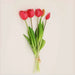 Soft silicone artificial tulip bouquet with vibrant red flowers and green leaves, perfect for home decor and events.