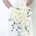 Stunning artificial orchid bouquet featuring white flowers and green buds, perfect for home decor and special occasions.