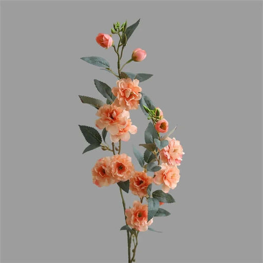 Artificial Camellia stem flowers in soft peach tones with green leaves, perfect for home decor and event enhancement.