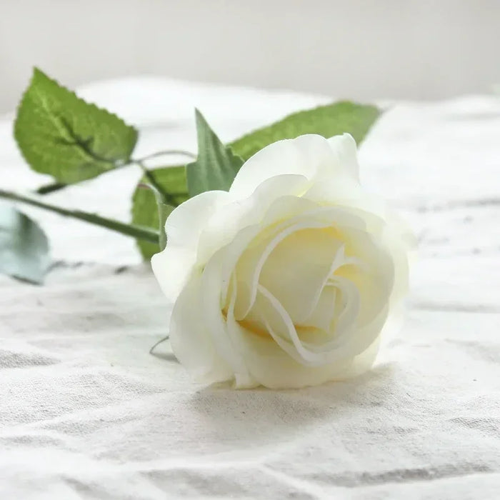 Latex real-touch artificial rose in white with realistic leaves and bloom, perfect for decor.