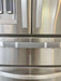 Black and white buffalo plaid handle cover on a stainless steel refrigerator, enhancing kitchen decor.