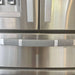 Black and white buffalo plaid handle cover on a stainless steel refrigerator, enhancing kitchen decor.