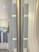 Stylish black and white buffalo plaid handle covers on refrigerator handles for decorative kitchen protection.