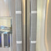 Stylish black and white buffalo plaid handle covers on refrigerator handles for decorative kitchen protection.
