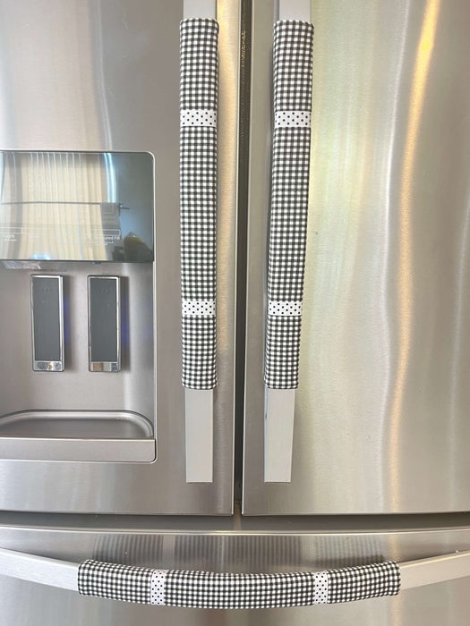 Stylish black and white buffalo plaid appliance handle covers on a stainless steel refrigerator.