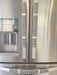 Stylish black and white buffalo plaid appliance handle covers on a stainless steel refrigerator.