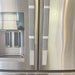 Stylish black and white buffalo plaid appliance handle covers on a stainless steel refrigerator.