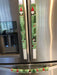 Gnomes on The Green Christmas Appliance Handle Covers on refrigerator handles in festive green, red, and white colors.