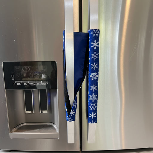 Blue snowflake-patterned handle cover draped over a fridge handle