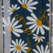 Stylish 14 '' size option blue appliance handle covers featuring white and yellow daisies, adding modern décor and protection