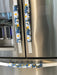 White and yellow daisy design on blue appliance handle covers for modern kitchen décor.