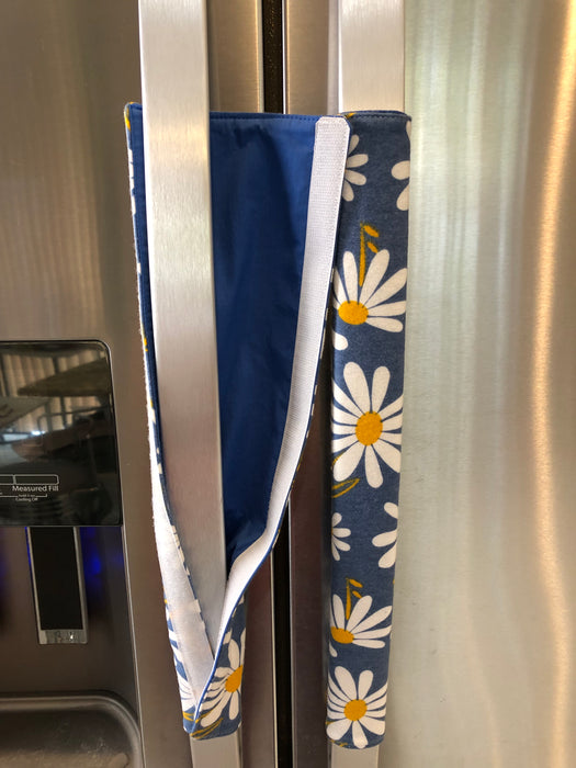 Stylish blue appliance handle covers featuring white and yellow daisies, showing blue backing for modern décor and protection