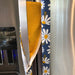 Stylish blue appliance handle covers featuring white and yellow daisies, showing yellow backing for modern décor and protection