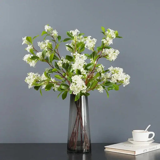 Artificial osmanthus tall stems arranged in a sleek vase, showcasing elegant floral design for home decor.
