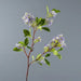 artificial osmanthus tall stems with realistic purple flowers and green leaves on a grey background.