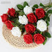 Artificial real-touch rose flower stems in red and white arranged in a woven basket with green leaves.