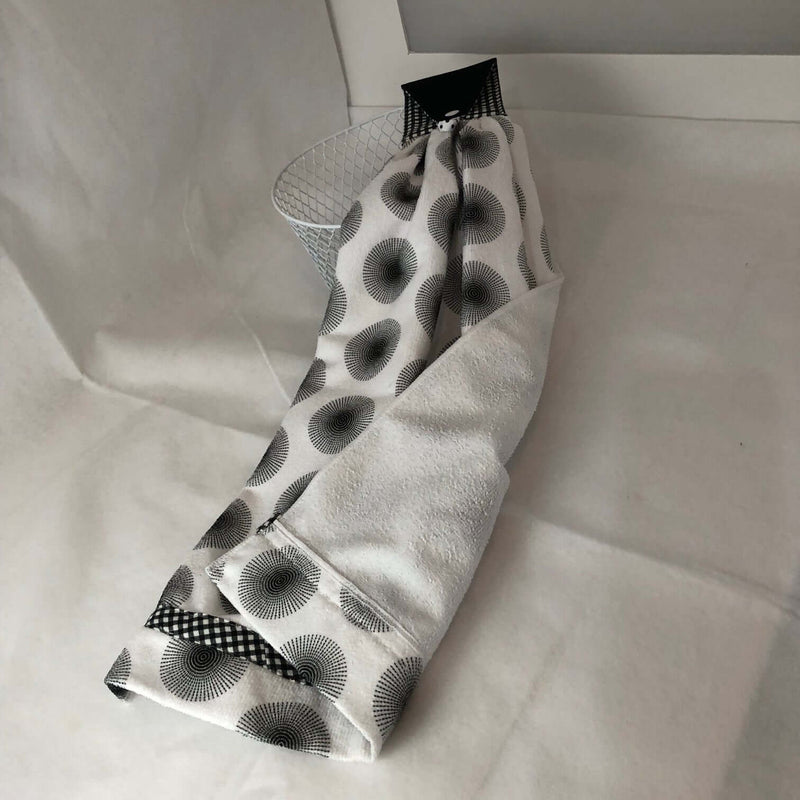 Black and white patterned hand towel on a white surface