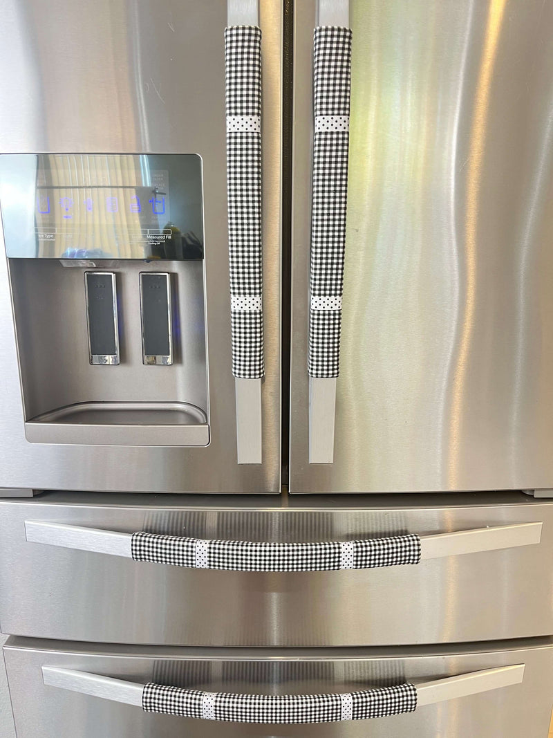 Buffalo plaid appliance handle covers on a stainless steel refrigerator, enhancing kitchen decor and preventing stains.