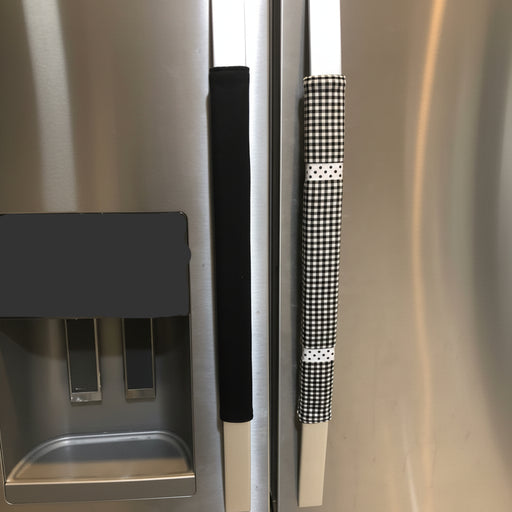 Buffalo plaid appliance handle covers on refrigerator handles in black and white colors.