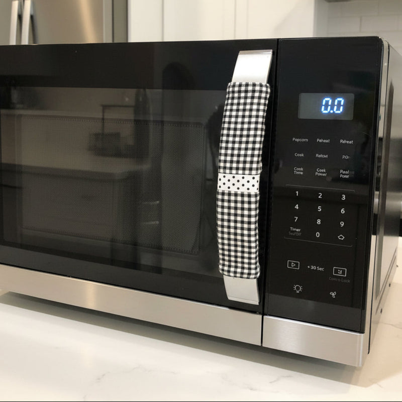 Buffalo plaid appliance handle covers in black and white on a kitchen appliance handle for style and protection