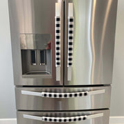 Stainless steel refrigerator with black and white checkered handle covers