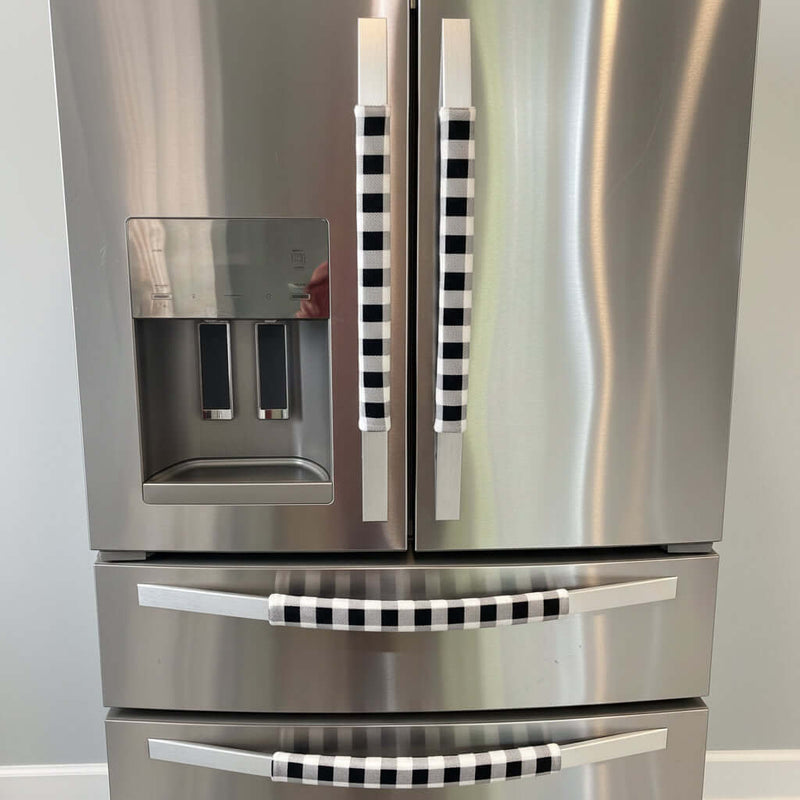 Stainless steel refrigerator with black and white checkered handle covers