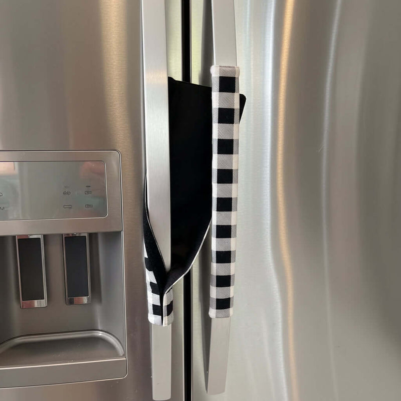 Black and white checkered handle cover draped over a refrigerator handle