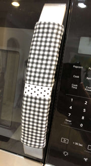 Buffalo plaid appliance handle covers in black and white on a kitchen appliance handle for style and protection