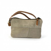 Canvas stamp wristlet pouch with leather accent detail, side view showing strap and texture