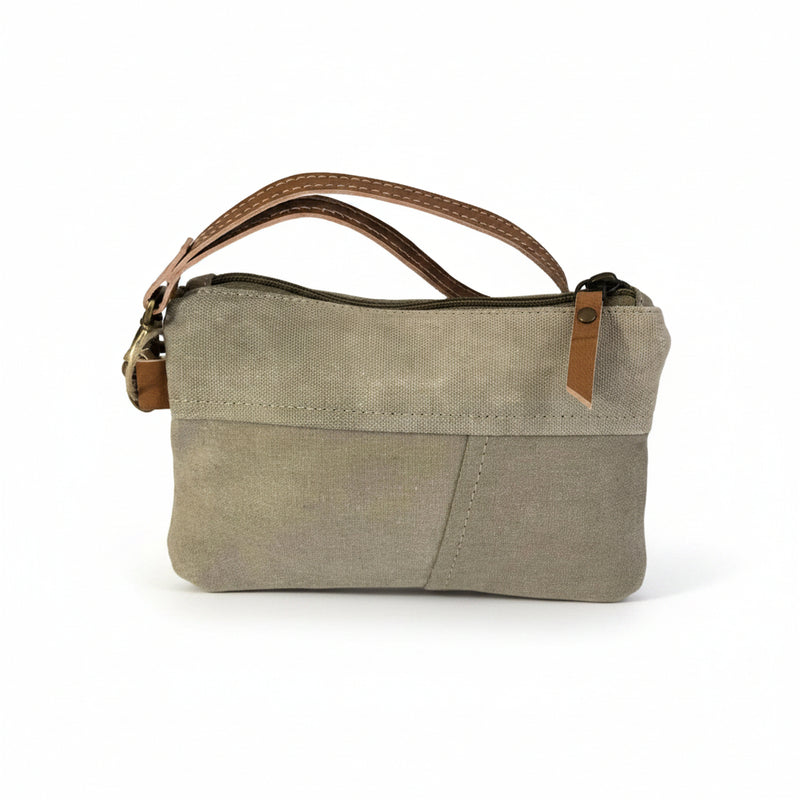 Canvas stamp wristlet pouch with leather accent detail, side view showing strap and texture