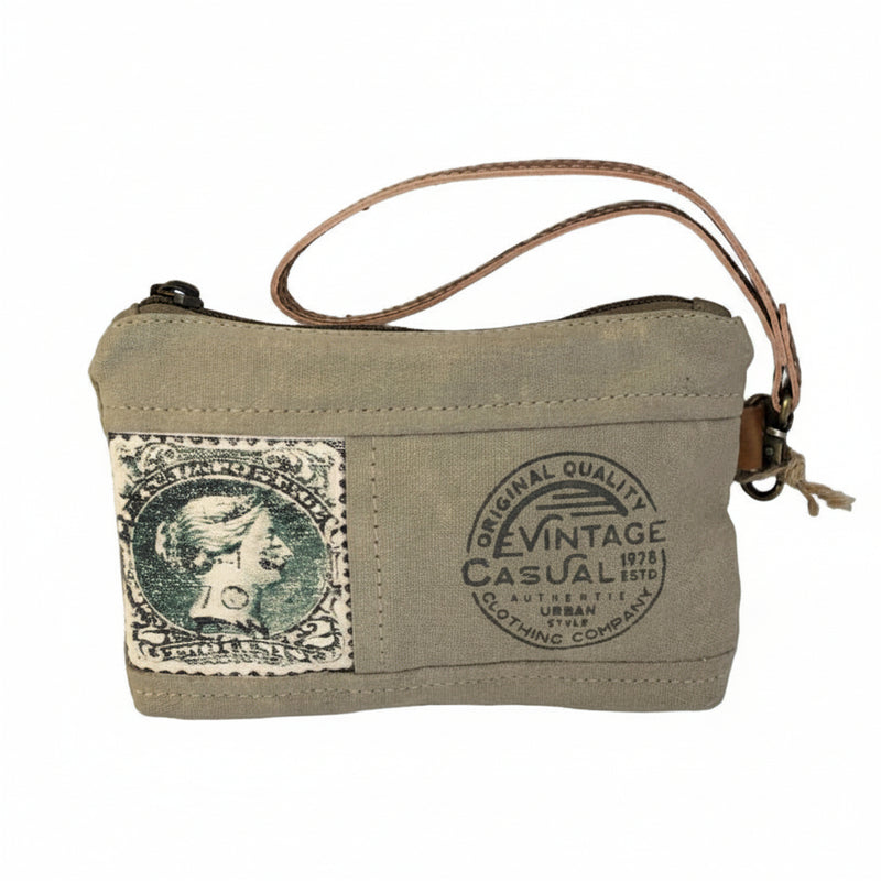 Upcycled military canvas and leather wristlet pouch with stamp print, front view showing compact size and zipper closure.