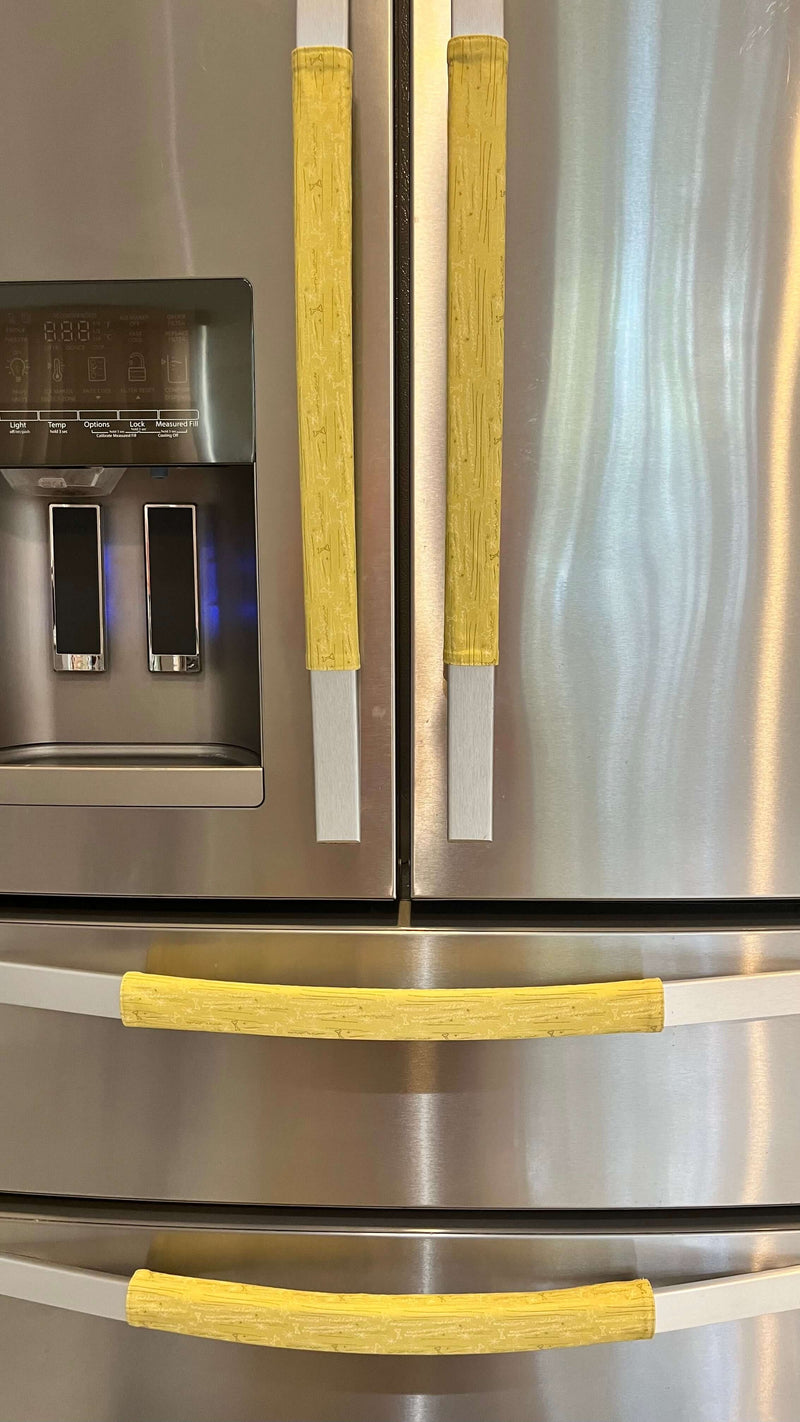 Cute puppy print on appliance handle covers enhancing a stainless steel refrigerator.